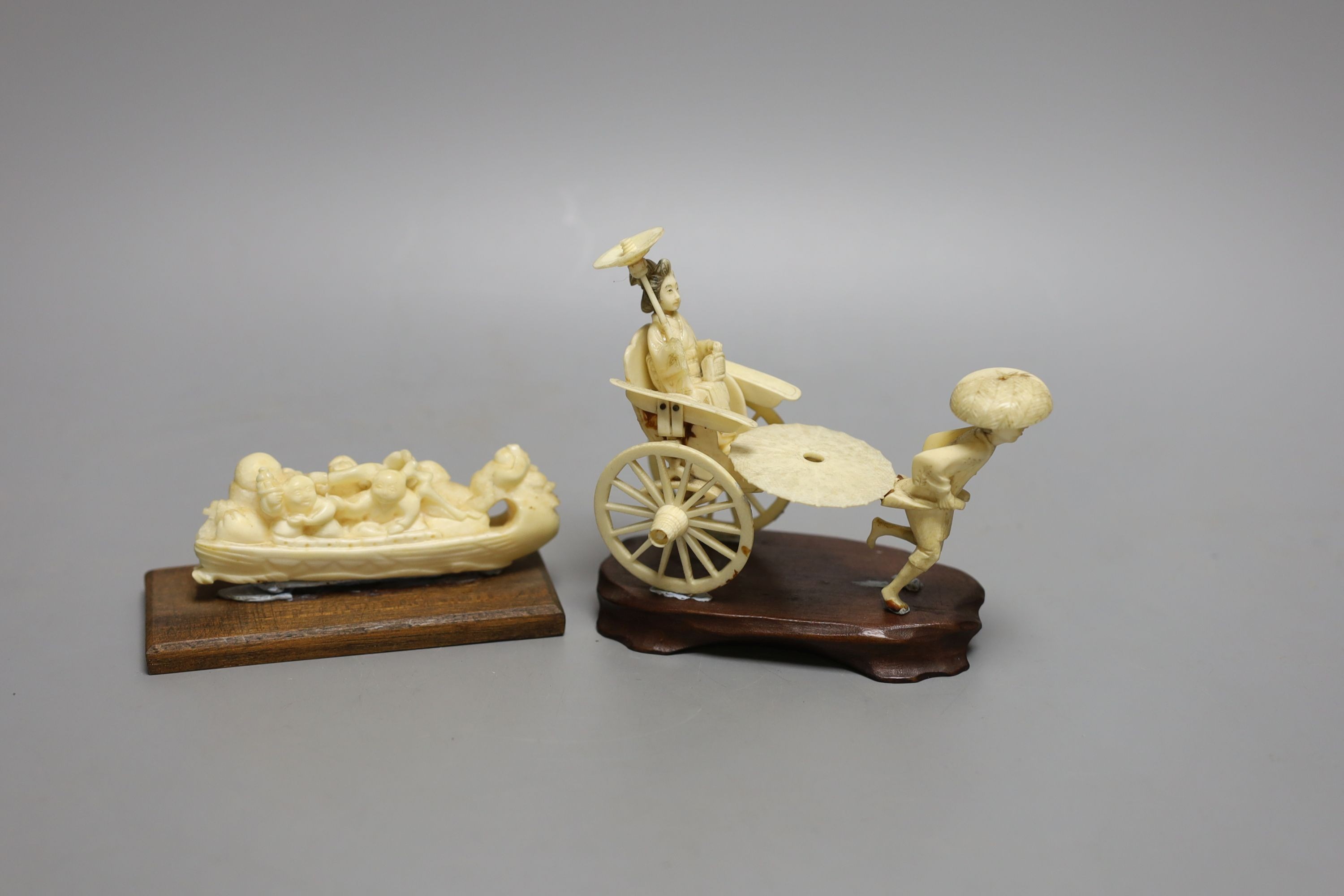 A Japanese ivory rickshaw group and a walrus ivory okimono of three immortals and attendants in a boat, early 20th century (2) wood stands - tallest 11cm tall